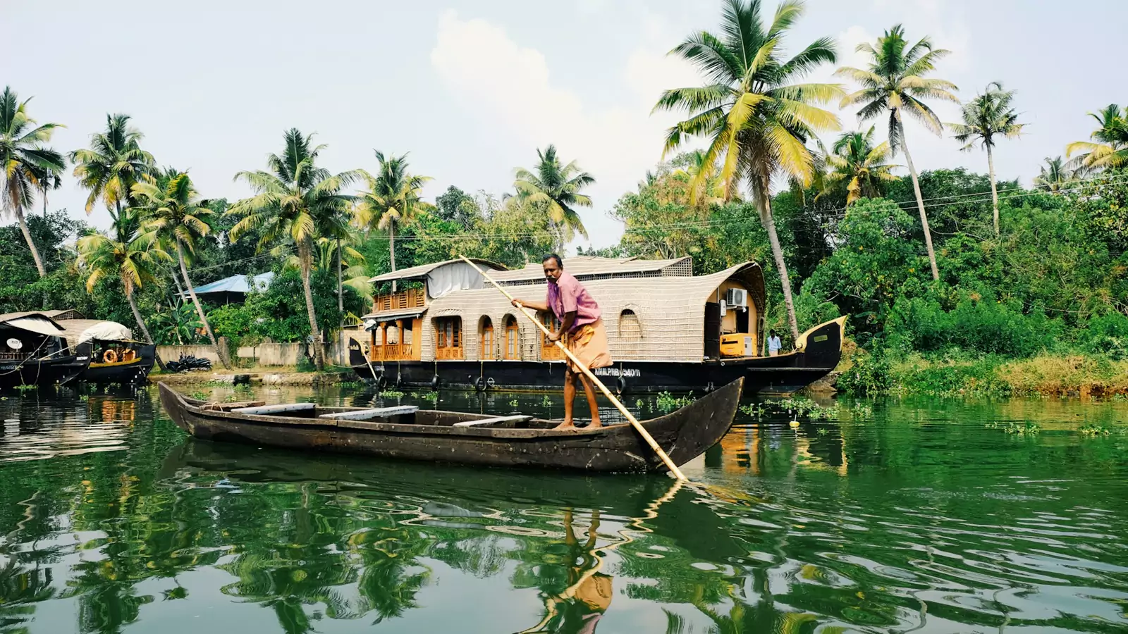 A canoe on a palm-lined Kerala canal