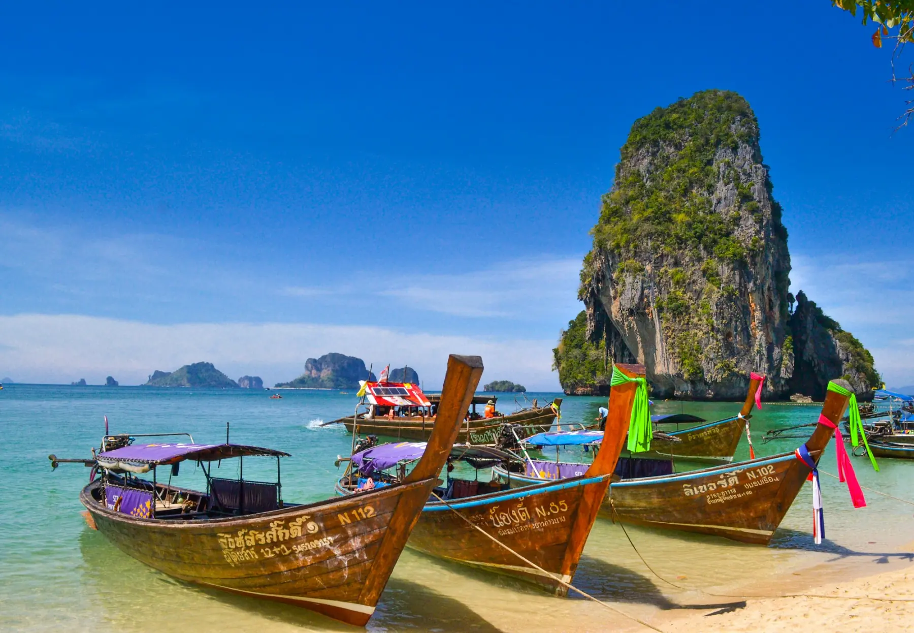 Longtail boats on a beach in southern Thailand